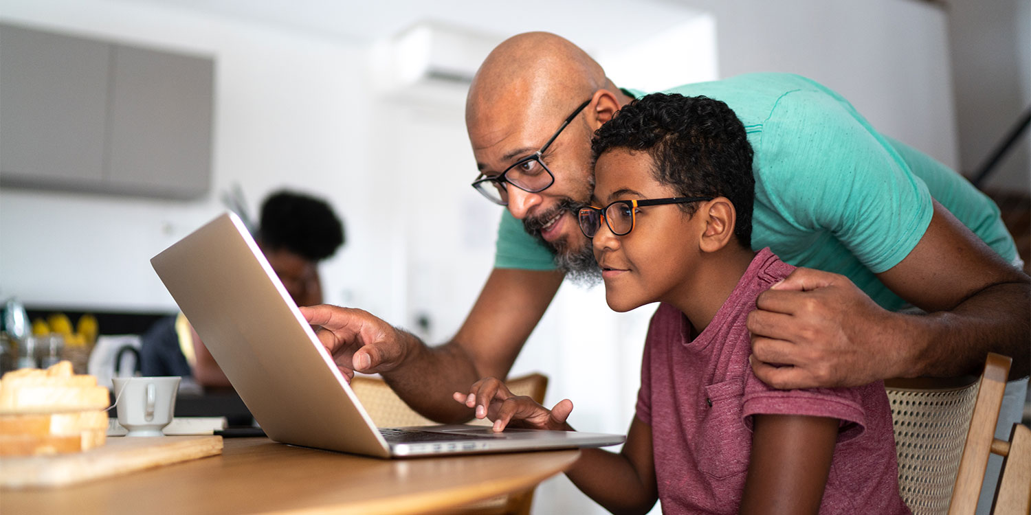 Parent and child using a laptop