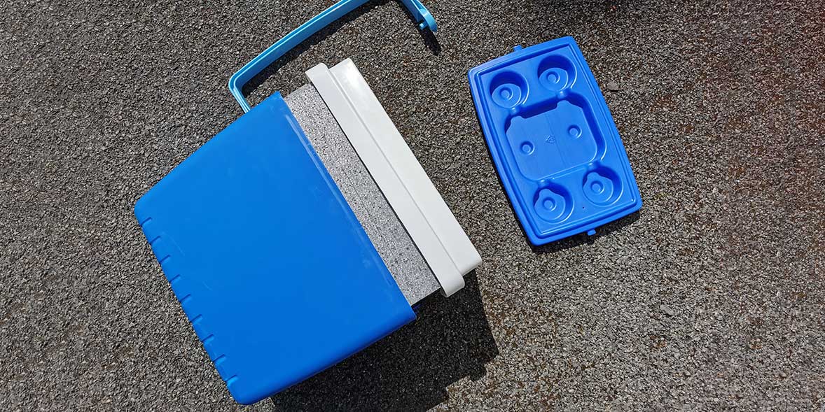 Blue cool box with broken handle after drop test