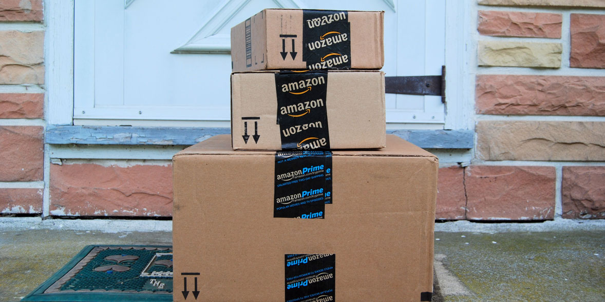 stack of Amazon packages on a doorstep