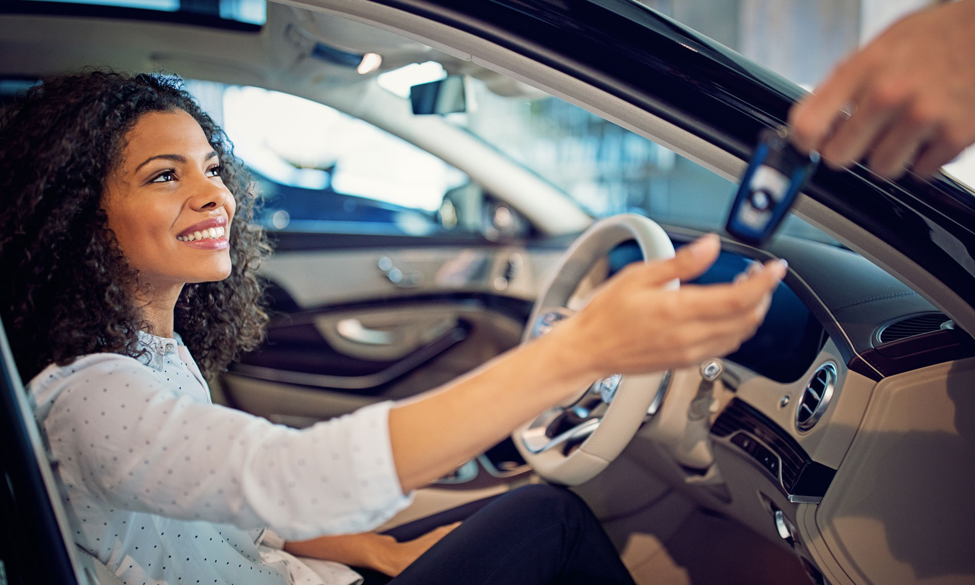Woman being handed new car keys